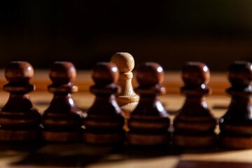 One white chess pawn among the black pawns. The concept of black lives matter