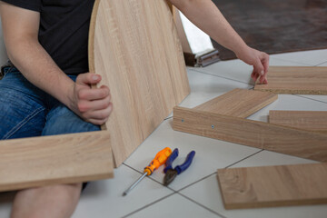Assembling of furniture with his own hands at home, close up