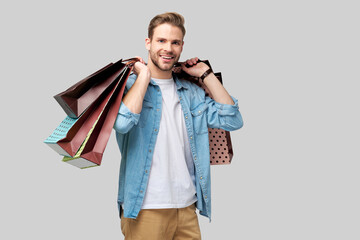 Portrait of a handsome young man with shopping bags