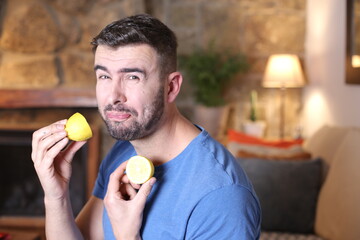 Man tasting a raw lemon 