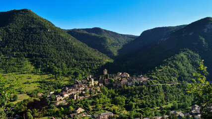 Fototapeta na wymiar Magnificent mountain landscape in the causses with a view of a village in the Massif Central.
