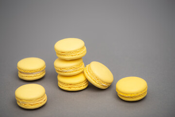 sweet yellow macarons on grey background