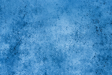 Abstract blue background with concrete texture and spots.