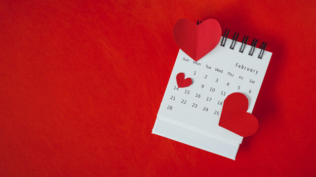 heart shape, paper cut, on white calendar ,page February, on grunge red paper background , for valentine's day concept