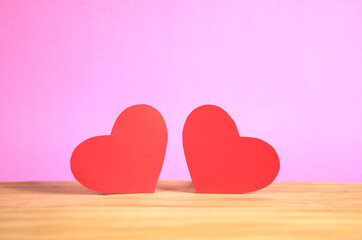 two hearts on pink background