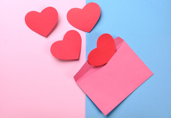 envelope with four paper hearts coming out