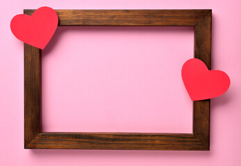 wooden frame with two red paper hearts