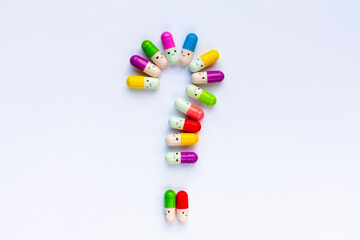 colorful pills forming a question mark