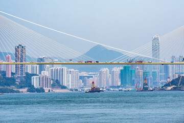 Suspension bridge on the city background.