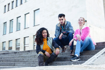 Obraz premium cute group of teenages at the building of university with books huggings, diversity nations real students lifestyle