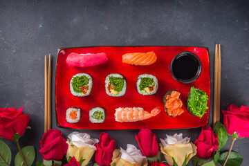Valentine day festive dinner idea. Menu, invitation background for Valentine day sushi roll set, with heart shaped decor and rose flowers bouquet. Top view with copy space for text