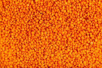Red lentils background, lentil pattern, lentil texture top view