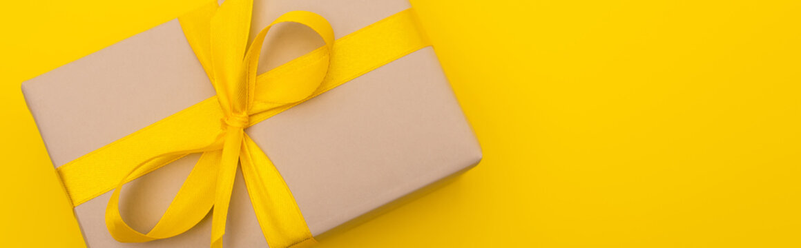 Too View Of Wrapped Present With Ribbon On Bow Isolated On Yellow, Banner