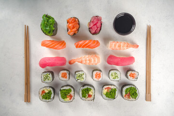  Japanese seafood sushi set.  Various sushi and sushi rolls on white background. Top view with copy space for text