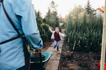 grandfather and grandson enjoying time together outdoors in family plant nursery