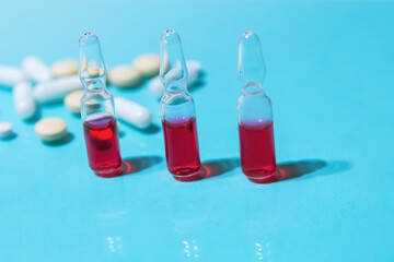 close up. ampoules and tablets on the table.