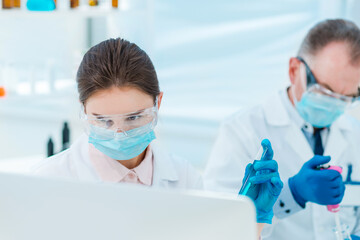 close up. female scientist with a test tube in her hands.