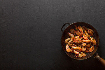 Fried shrimp in pan copy space for text, top view