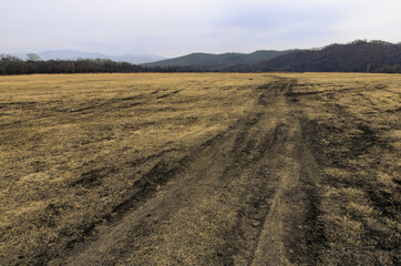 Tire marks in the field, detail of footprints in the field. car footprint