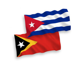 National vector fabric wave flags of East Timor and Cuba isolated on white background. 1 to 2 proportion.