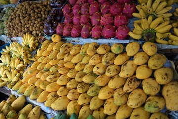 Fresh Fruits, Mango, Banana, Watermelon, Dragon Fruits and more on the counter of Stall in the market, Pataya, Thailand