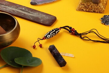 Tibetan dzi bead amulet necklace, tibetan singing bowl and other Success and prosperity symbols on...