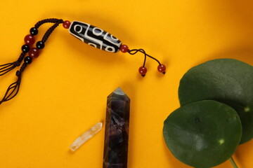 Tibetan dzi bead amulet necklace, tibetan singing bowl and other Success and prosperity symbols on...