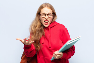blonde woman looking angry, annoyed and frustrated screaming wtf or what’s wrong with you