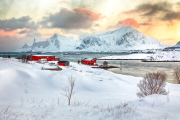 Stunning morning view of Torsfjorden fjord with Ramberg  village and snowy mountain peaks at backgroud
