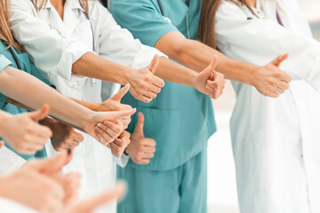 big team of medical professionals showing thumbs up.