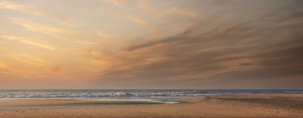 Minimalist seascape at sunrise with colorful cloudy sky. Beautiful panoramic view over Atlantic ocean