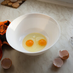 Raw eggs in a bowl for making an omelet or dough, close up