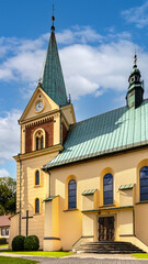 Fototapeta premium St. John Baptist parish church in historic royal open-air museum town of Lanckorona in mountain region of Lesser Poland
