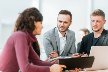 young employees discussing problems at a group meeting.