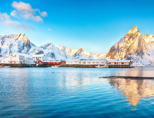 Fantastic winter view on Hamnoy village with port and  Olstinden peak on background.