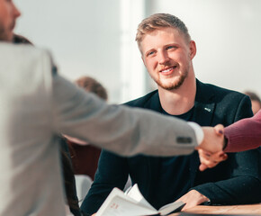 Fototapeta premium lucky applicant shaking hands with the employer during the interview