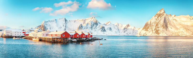 Fototapeta premium Traditional Norwegian red wooden houses (rorbuer) on the shore of Reinefjorden near Hamnoy village.