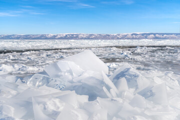 Natural ice stack with mountains blue sky at Baikal lake, Siberia, Russia.