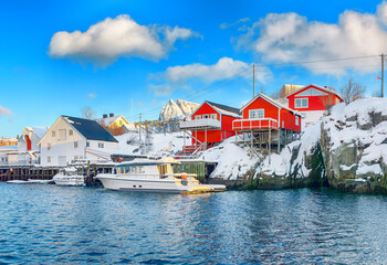 Fototapeta na wymiar Traditional Norwegian red wooden houses (rorbuer) on the shore of Reinefjorden near Hamnoy village.