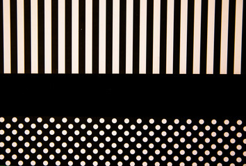 The paper is black and white. Different geometric shapes. White circles and stripes. Abstract background and texture.