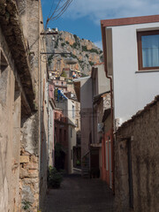 View of narrow streets of old romantic mountain village Baunei with stone houses. Ogliastra, Sardinia, Italy, Sunny summer afternoon