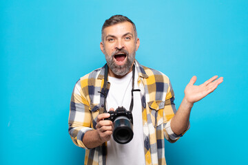 adult man feeling happy, excited, surprised or shocked, smiling and astonished at something...