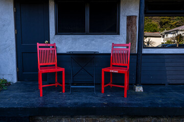 Fototapeta na wymiar Two red Chairs are placed in front of coffee shop. 