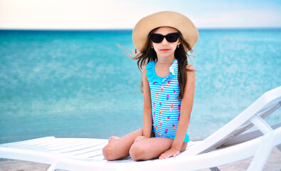 Cute little girl has fun on the beach. 