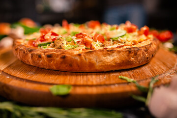 Tasty pepperoni pizza and cooking ingredients tomatoes basil on black concrete background. Top view of hot pepperoni pizza. With copy space for text. Flat lay. Banner