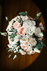 wedding bouquet of white and pastel roses on the table