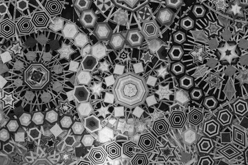 Black and white image with geometric background made from multicolor yarn.