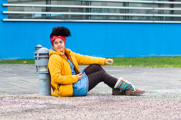 young woman in the city with her cell phone and laptop