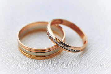 gold wedding rings on a white fabric surface. preparing for the wedding. close-up, macro