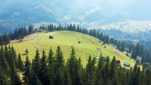 Aerial view from drone. Aerial view amazing over of the Carpathian Mountains or Carpathians with beautiful rural landscape, sunny day, blue sky with white clouds